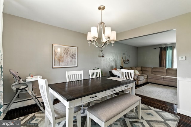312 Wellington, Reading, PA 19609 - dining area featuring a chandelier, wood finished floors, and a wainscoted wall