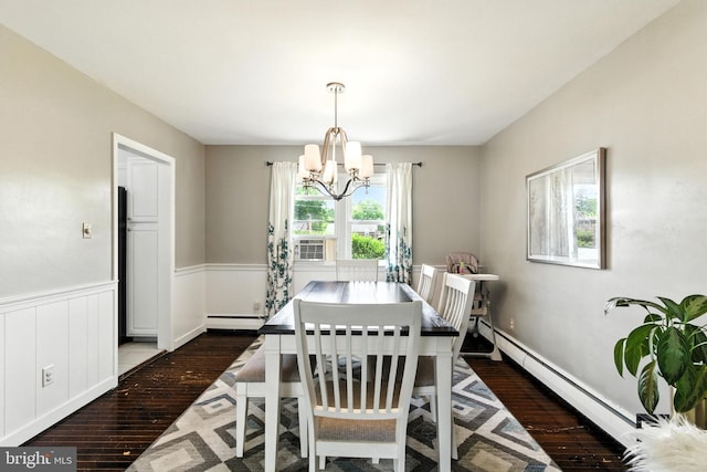 312 Wellington, Reading, PA 19609 - dining area featuring a baseboard heating unit, wood-type flooring, a chandelier, baseboard heating, and a wainscoted wall