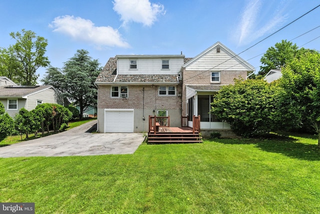 312 Wellington, Reading, PA 19609 - rear view of house with a sunroom, asphalt driveway, a garage, a deck, and brick siding