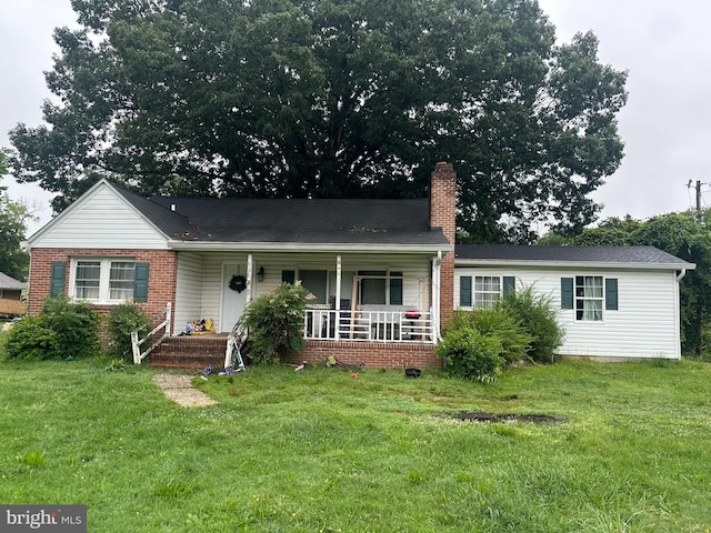 906 Washington Ave, La Plata, MD 20646 - view of front of property with covered porch, a chimney, a front yard, and brick siding