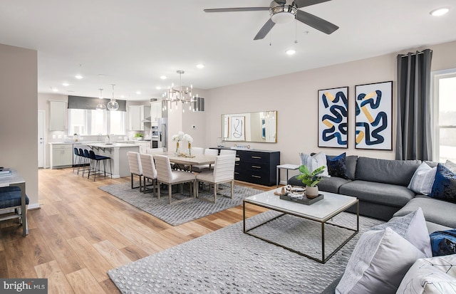 3929 Walnut St, Fairfax, VA 22030 - living room featuring a ceiling fan, light wood-type flooring, recessed lighting, and a chandelier