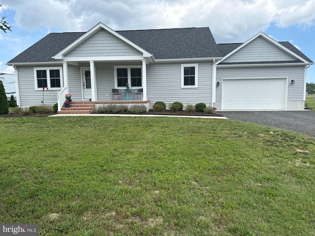 6236 Solomons Cir, Hurlock, MD 21643 - view of front of house with a porch, asphalt driveway, a garage, a front lawn, and roof with shingles