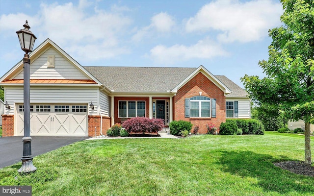 134 Woodhaven Dr, Gettysburg, PA 17325 - view of front facade with brick siding, asphalt driveway, a front lawn, a garage, and a standing seam roof