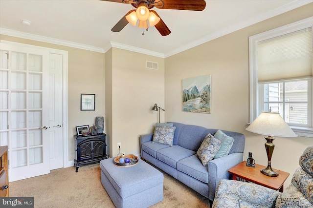 134 Woodhaven Dr, Gettysburg, PA 17325 - living room with a wood stove, light colored carpet, ornamental molding, and ceiling fan