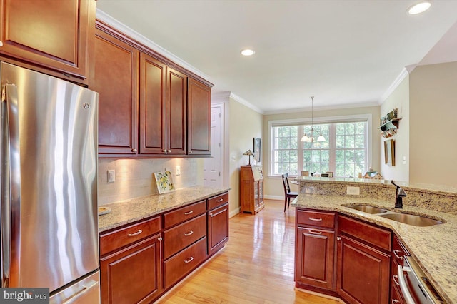 134 Woodhaven Dr, Gettysburg, PA 17325 - kitchen with appliances with stainless steel finishes, crown molding, light wood finished floors, light stone countertops, and tasteful backsplash