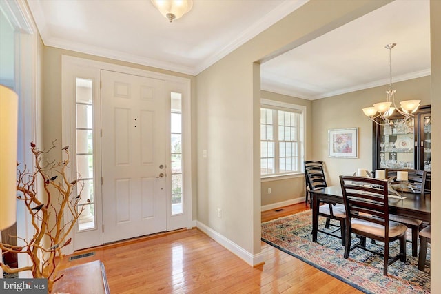 134 Woodhaven Dr, Gettysburg, PA 17325 - entrance foyer with a chandelier, light wood-style flooring, and ornamental molding