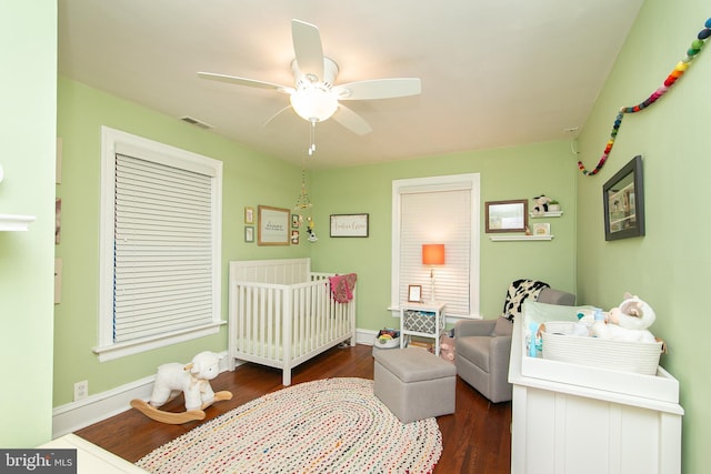319 E Atlantic Ave, Haddon Heights, NJ 08035 - bedroom with a nursery area, dark wood-style flooring, and ceiling fan