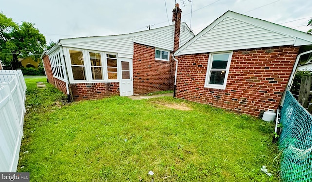 8237 Verree Rd, Philadelphia, PA 19111 - rear view of house featuring a fenced backyard, brick siding, and a chimney