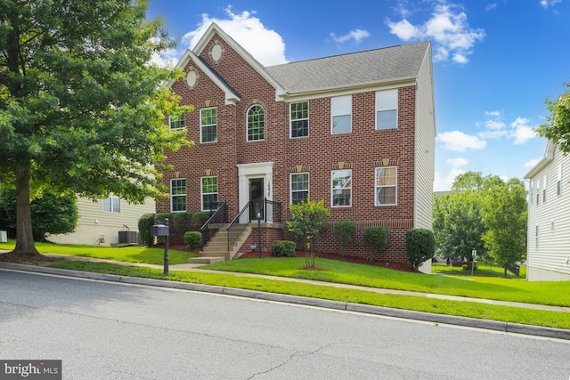 16435 Regatta Ln, Woodbridge, VA 22191 - view of front facade with brick siding and a front yard