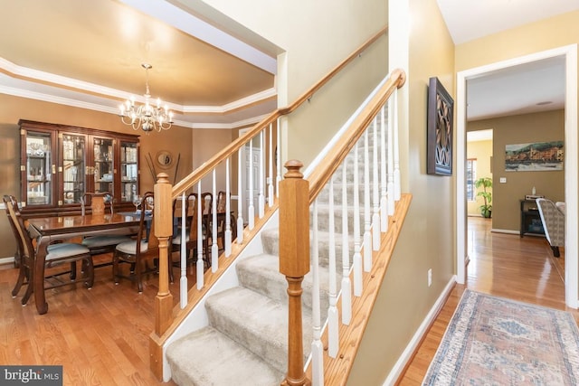 16435 Regatta Ln, Woodbridge, VA 22191 - stairway with a chandelier, wood finished floors, and ornamental molding