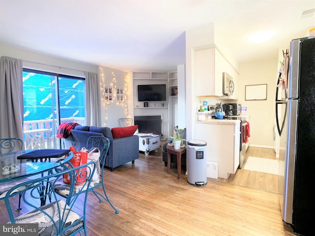 304 W Wildey St, Philadelphia, PA 19123 - dining space featuring light wood-type flooring and a fireplace