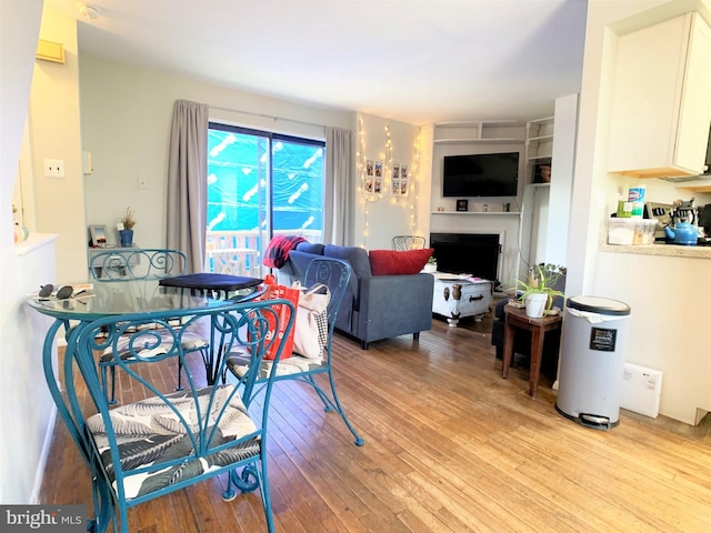 304 W Wildey St, Philadelphia, PA 19123 - dining space with light wood finished floors and a fireplace