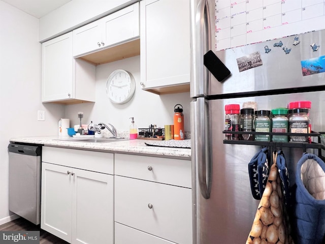 304 W Wildey St, Philadelphia, PA 19123 - kitchen featuring appliances with stainless steel finishes, white cabinets, dark wood finished floors, and light stone counters
