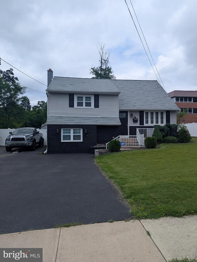 505 Spruce Ave, Pitman, NJ 08071 - tri-level home with a chimney, covered porch, a front lawn, and driveway