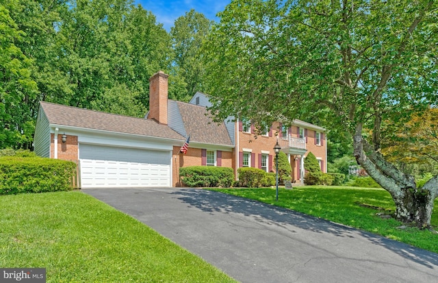 1202 Forestville Dr, Great Falls, VA 22066 - view of front of property with asphalt driveway, a garage, a front yard, brick siding, and a chimney