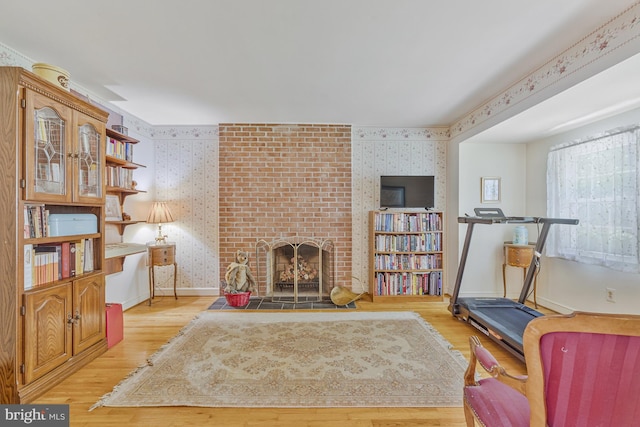 1202 Forestville Dr, Great Falls, VA 22066 - living room featuring wallpapered walls, light wood-type flooring, and a brick fireplace