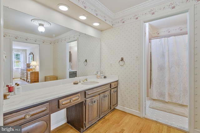 1202 Forestville Dr, Great Falls, VA 22066 - full bathroom with wood finished floors, ornamental molding, vanity, a shower with curtain, and wallpapered walls