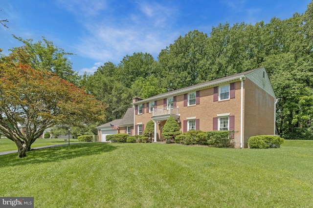 1202 Forestville Dr, Great Falls, VA 22066 - view of front of property with a front lawn, a balcony, a garage, and a chimney