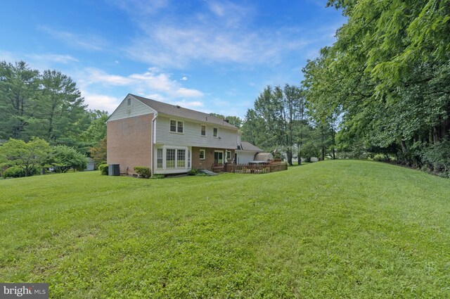 1202 Forestville Dr, Great Falls, VA 22066 - rear view of property featuring a lawn, a wooden deck, and brick siding