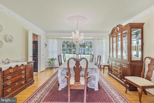 1202 Forestville Dr, Great Falls, VA 22066 - dining room featuring a chandelier, light wood-style flooring, and crown molding