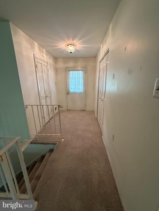 12157 Pineneedle Ct, Woodbridge, VA 22192 - corridor featuring light carpet and an upstairs landing