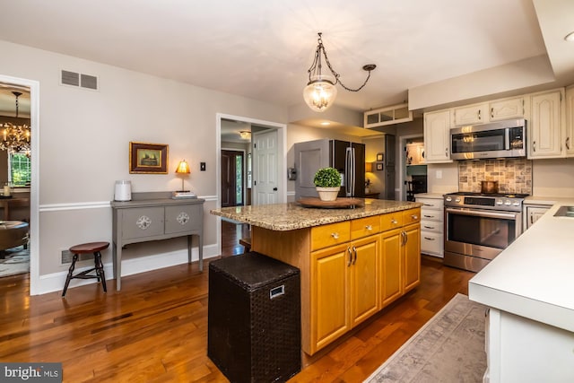 20 Mooney Ln, Chester Springs, PA 19425 - kitchen featuring stainless steel appliances, a chandelier, a kitchen island, dark wood finished floors, and decorative backsplash
