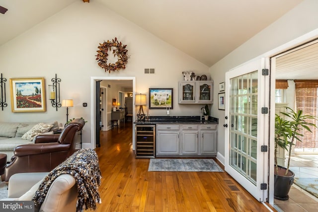 20 Mooney Ln, Chester Springs, PA 19425 - indoor wet bar with beverage cooler, light wood-style flooring, healthy amount of natural light, high vaulted ceiling, and french doors