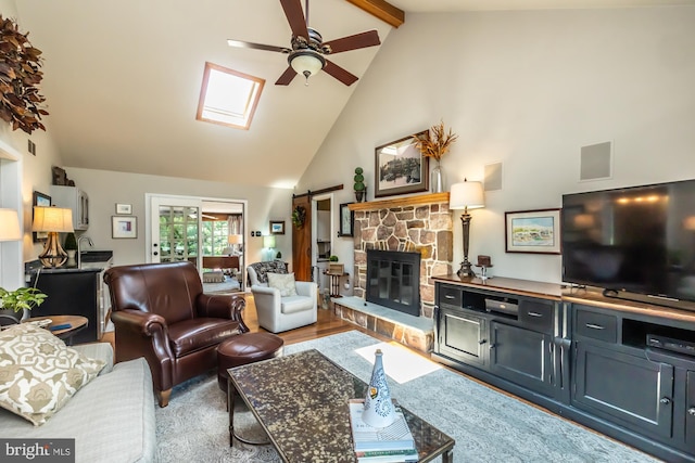 20 Mooney Ln, Chester Springs, PA 19425 - living area featuring a ceiling fan, high vaulted ceiling, a stone fireplace, beamed ceiling, and a skylight