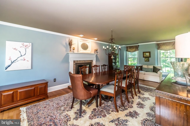 20 Mooney Ln, Chester Springs, PA 19425 - dining area with crown molding, a brick fireplace, wood finished floors, and a chandelier