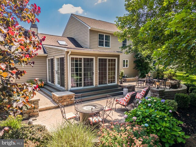 20 Mooney Ln, Chester Springs, PA 19425 - rear view of house with a fire pit, a patio, and roof with shingles