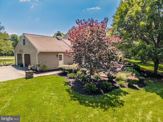 20 Mooney Ln, Chester Springs, PA 19425 - view of property exterior featuring a chimney, a yard, and concrete driveway