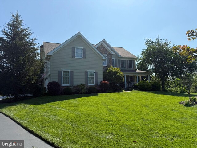 1666 Royal Berkshire Cir, West Chester, PA 19380 - traditional home featuring a front lawn, a chimney, and stone siding