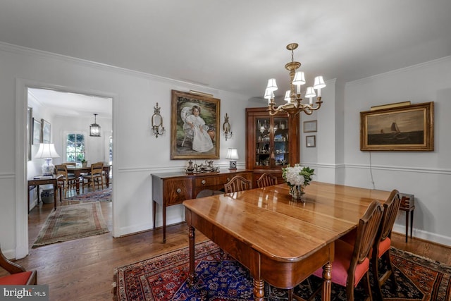 717 S Royal St, Alexandria, VA 22314 - dining space featuring wood finished floors, a chandelier, and crown molding