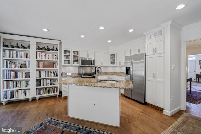 717 S Royal St, Alexandria, VA 22314 - kitchen featuring stainless steel appliances, crown molding, white cabinets, light stone countertops, and a center island with sink