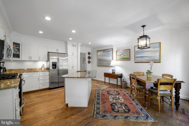 717 S Royal St, Alexandria, VA 22314 - kitchen with appliances with stainless steel finishes, crown molding, glass insert cabinets, wood finished floors, and stone countertops