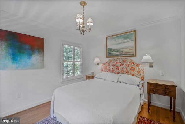 717 S Royal St, Alexandria, VA 22314 - bedroom featuring a chandelier, crown molding, and wood finished floors