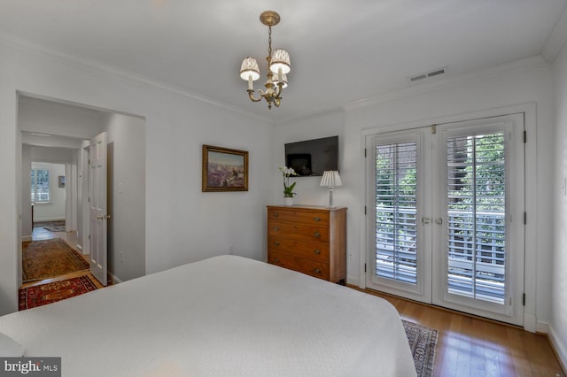 717 S Royal St, Alexandria, VA 22314 - bedroom with access to outside, a chandelier, wood finished floors, and ornamental molding