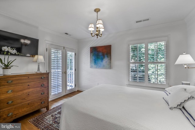 717 S Royal St, Alexandria, VA 22314 - bedroom with access to exterior, a chandelier, multiple windows, ornamental molding, and wood finished floors