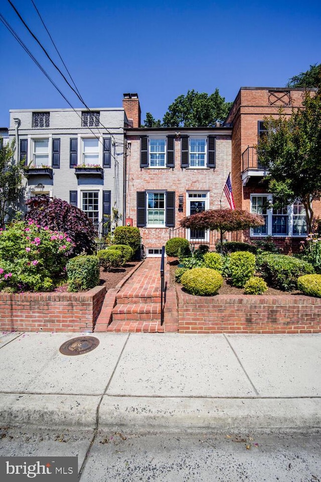 717 S Royal St, Alexandria, VA 22314 - view of front of house with a chimney and brick siding