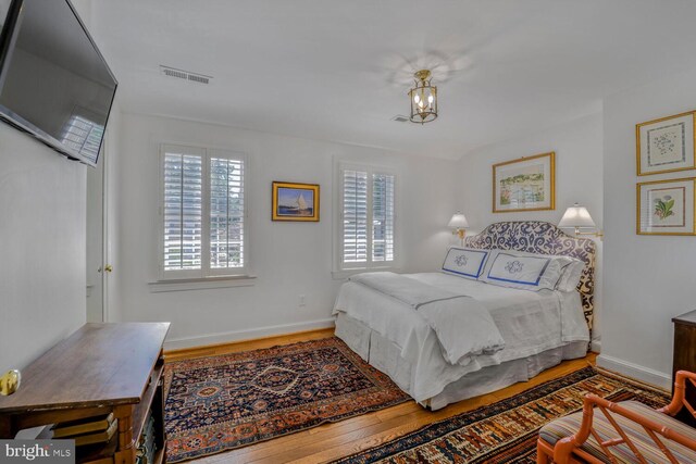 717 S Royal St, Alexandria, VA 22314 - bedroom featuring wood finished floors and a chandelier