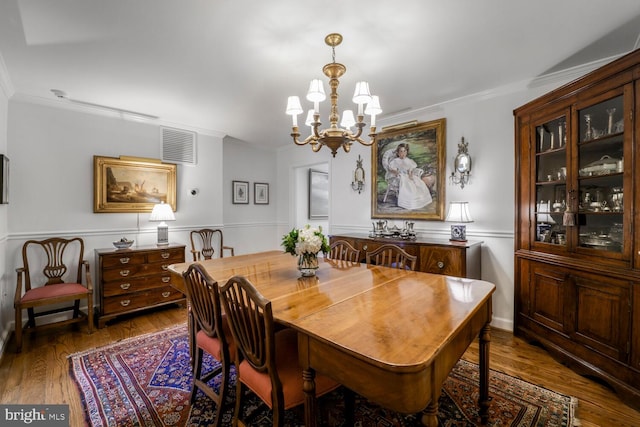 717 S Royal St, Alexandria, VA 22314 - dining room featuring a chandelier, ornamental molding, wood finished floors, and a wainscoted wall