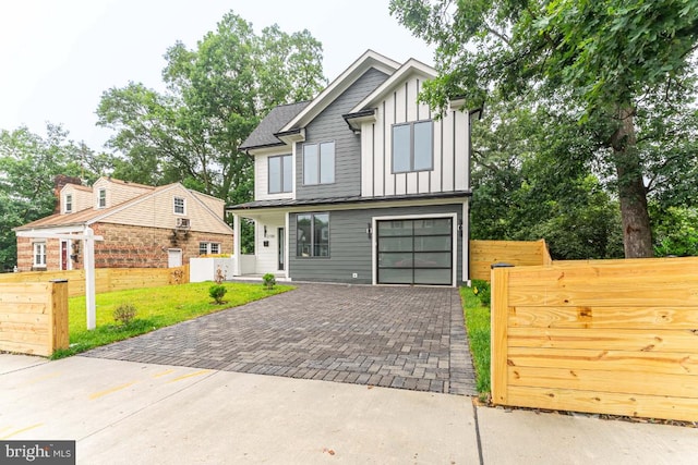 2100 S Nelson St, Arlington, VA 22204 - view of front of house featuring decorative driveway, board and batten siding, and an attached garage