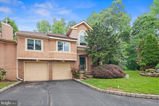 124 Kingsland Cir, Monmouth Junction, NJ 08852 - view of front facade with asphalt driveway, stucco siding, a garage, a front lawn, and brick siding