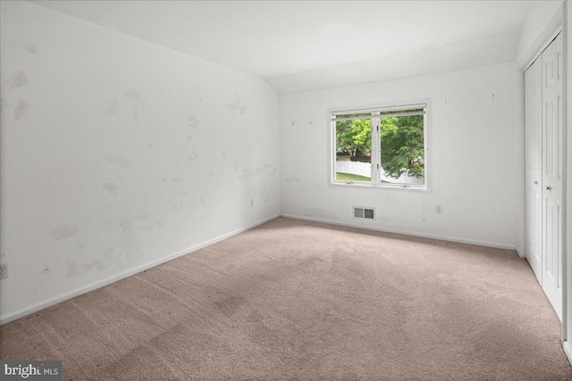 124 Kingsland Cir, Monmouth Junction, NJ 08852 - unfurnished bedroom with light colored carpet, a closet, and vaulted ceiling