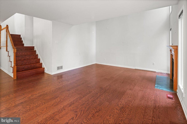 124 Kingsland Cir, Monmouth Junction, NJ 08852 - unfurnished living room with wood finished floors, stairs, and a fireplace with flush hearth