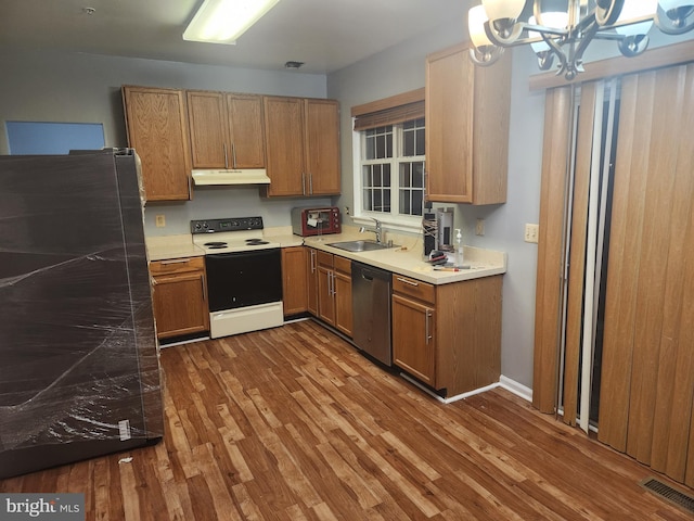 10203 Thundercloud Ct, Springdale, MD 20774 - kitchen with white range with electric stovetop, stainless steel dishwasher, under cabinet range hood, a chandelier, and wood finished floors
