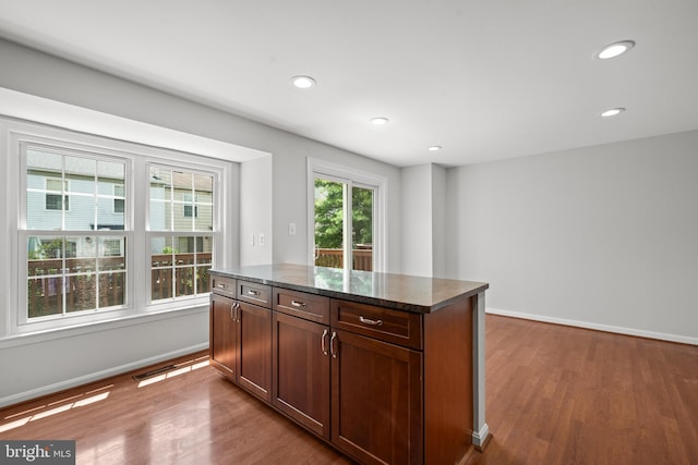 6558 Lochleigh Ct, Alexandria, VA 22315 - kitchen with wood finished floors, recessed lighting, dark stone counters, and a kitchen island