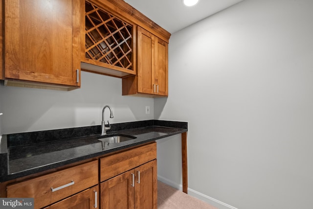 6558 Lochleigh Ct, Alexandria, VA 22315 - kitchen featuring brown cabinets, dark stone countertops, carpet floors, and recessed lighting