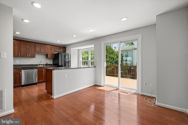 6558 Lochleigh Ct, Alexandria, VA 22315 - kitchen with dishwasher, freestanding refrigerator, wood finished floors, recessed lighting, and a peninsula
