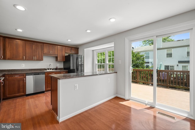 6558 Lochleigh Ct, Alexandria, VA 22315 - kitchen featuring dishwasher, freestanding refrigerator, wood finished floors, dark stone countertops, and recessed lighting